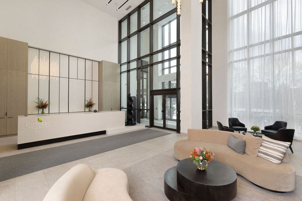 A modern living room with a glass door and a black coffee table.