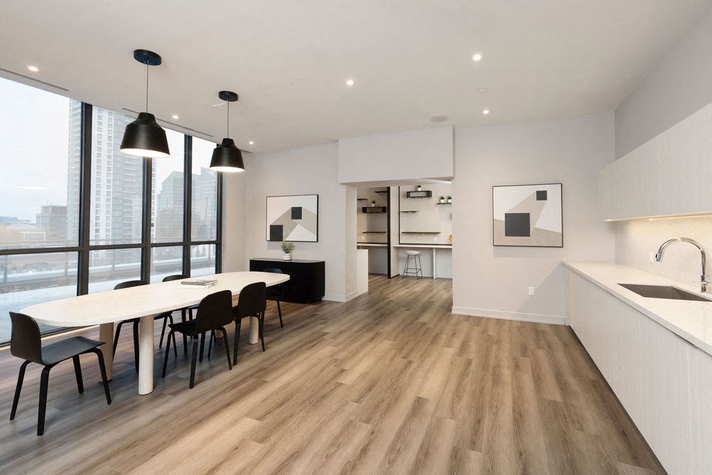 A modern kitchen with a dining table and chairs.