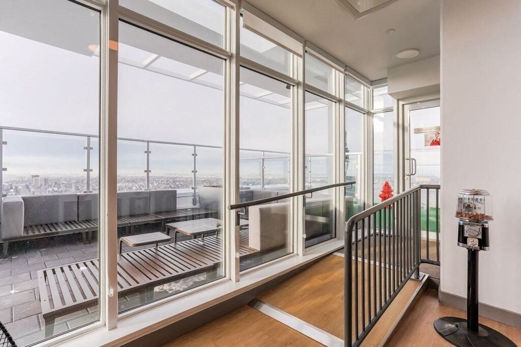 a view of the city from a room with windows and a staircase