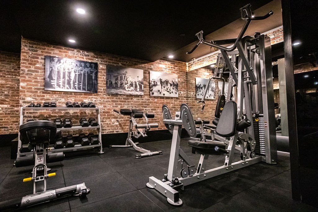 a gym with weights and other gym equipment in a home gym