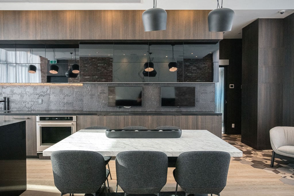 a kitchen and dining room with a marble table and chairs