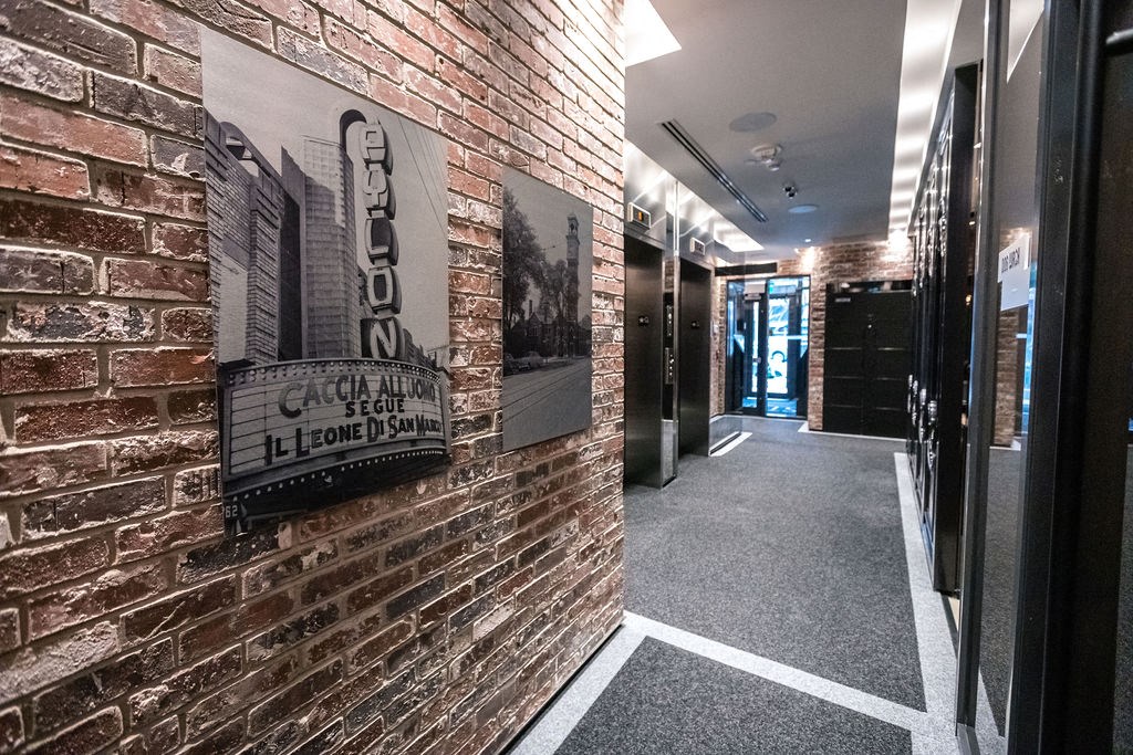 a brick wall with a sign on it in a corridor