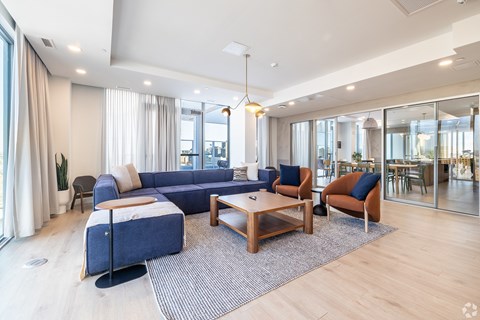 A modern living room with a blue sofa and wooden coffee table.