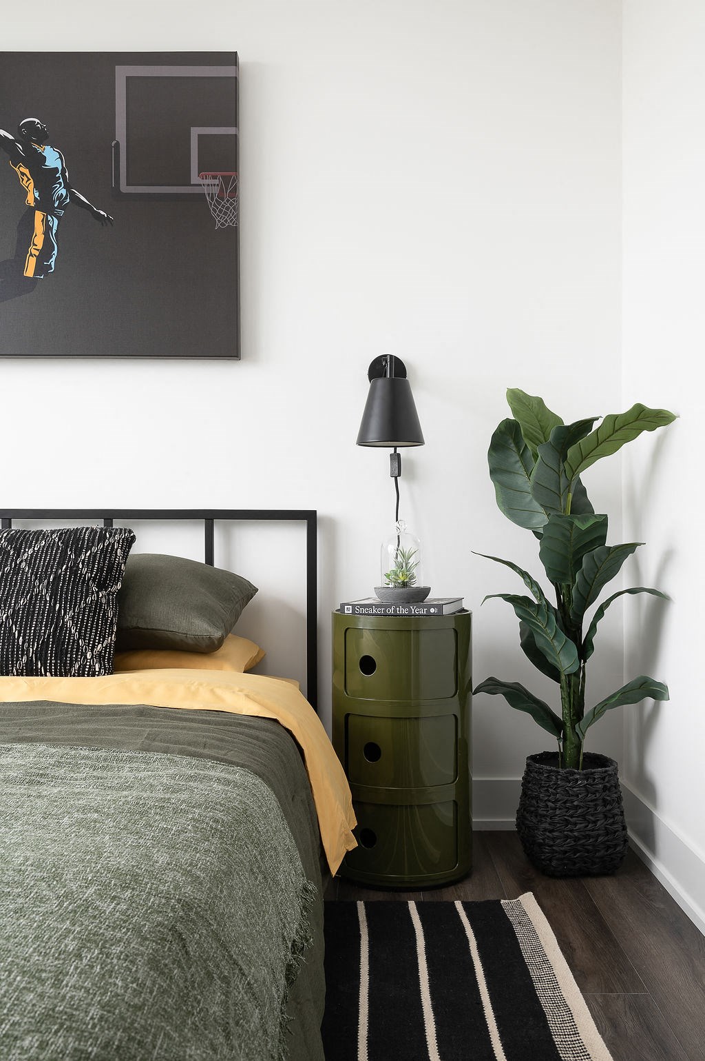 bed with nightstand and plant
