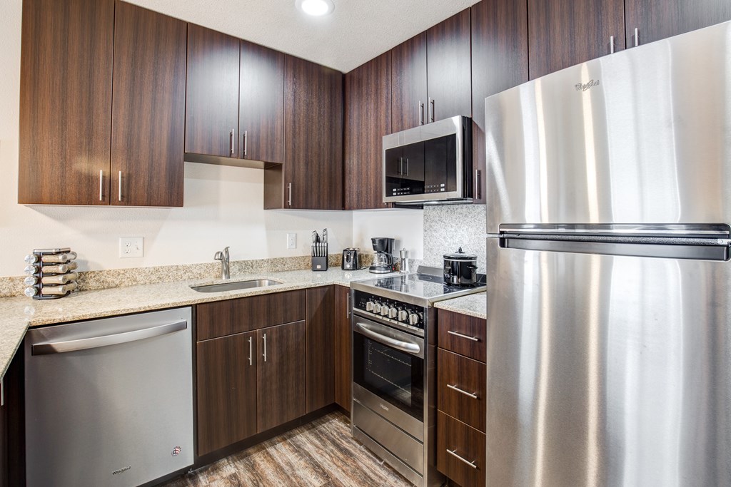 A modern kitchen with a stainless steel refrigerator.