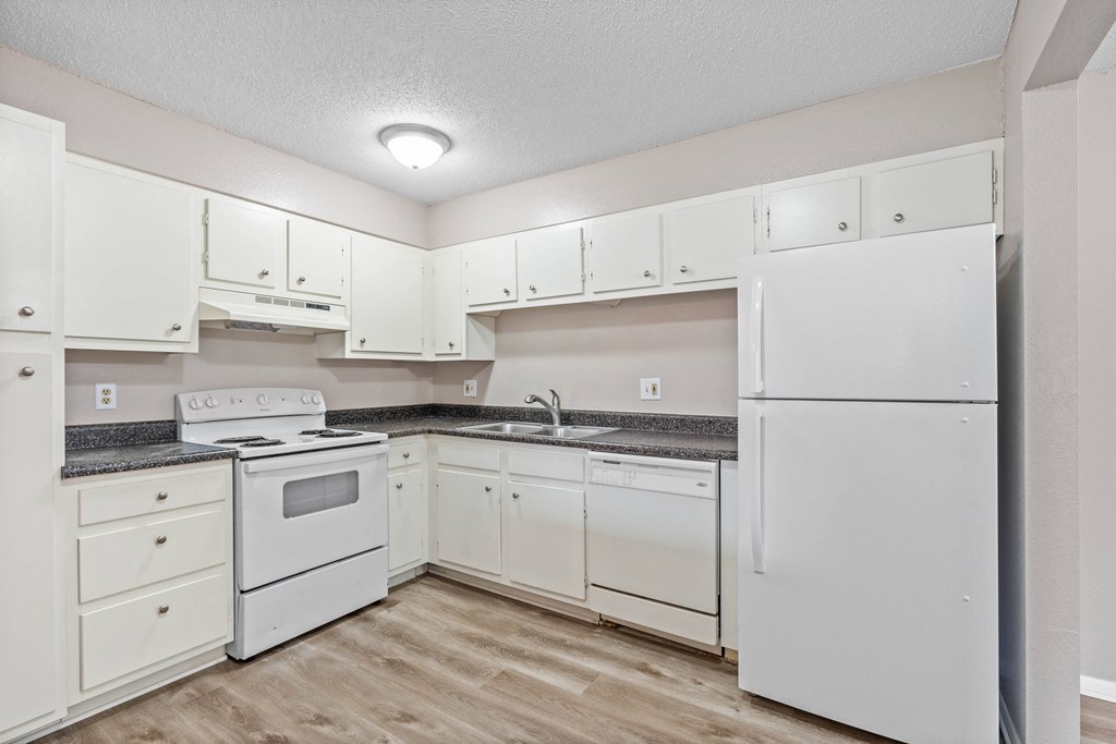 a kitchen with white cabinets and white appliances