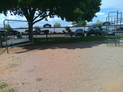 A park with a bench and a tree.