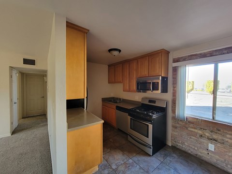 A kitchen with a stove top oven and microwave.