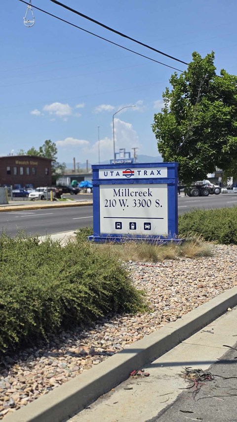 A blue sign with the word "UTRAX" on it is in front of a building.