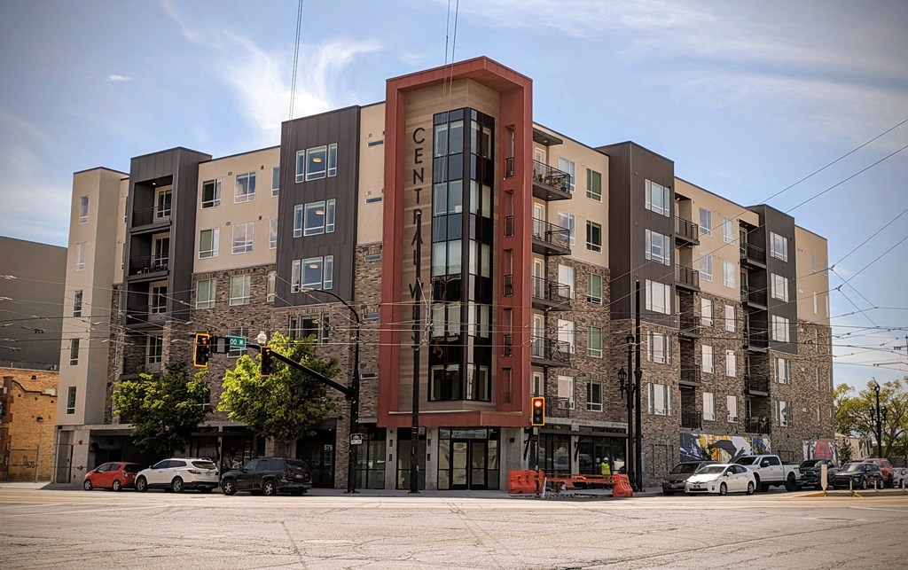 A large apartment building with a traffic light in front of it