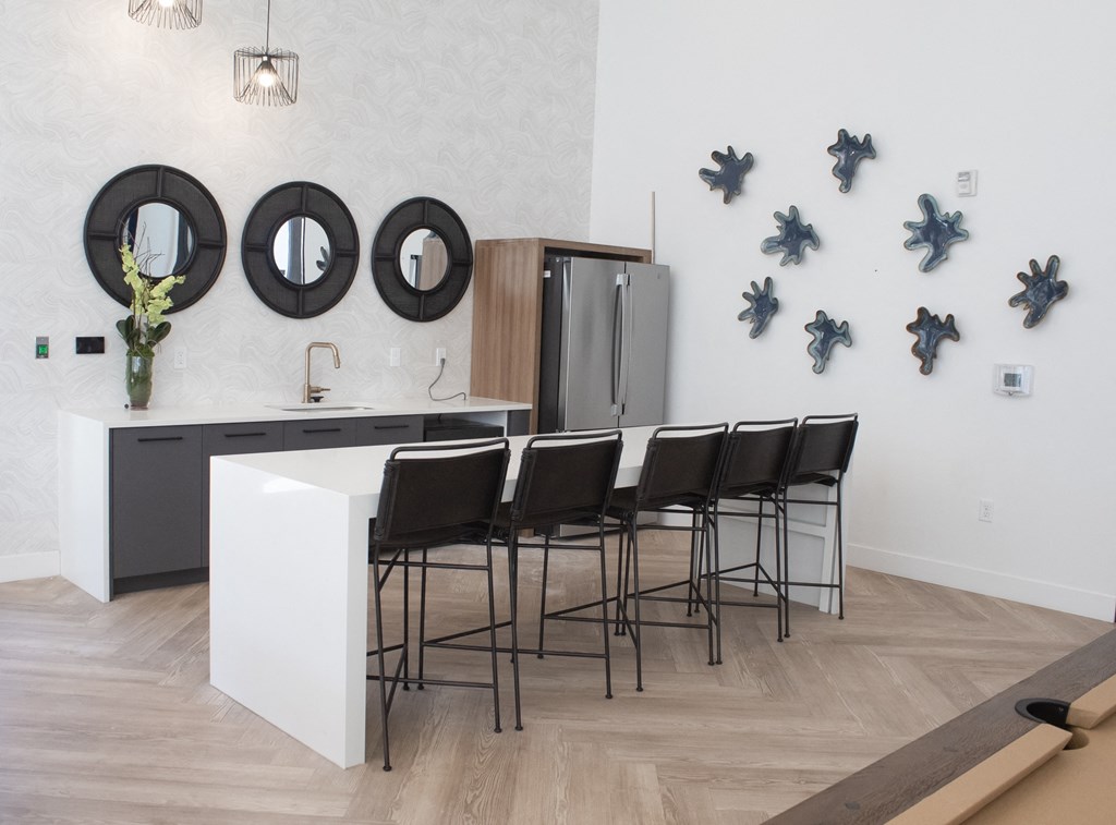 a white kitchen with black mirrors on the wall
