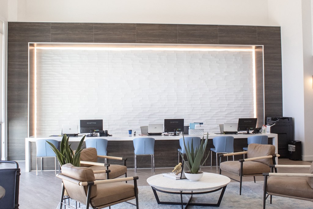 A room filled with furniture and a large white brick wall