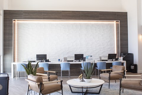 A room filled with furniture and a large white brick wall