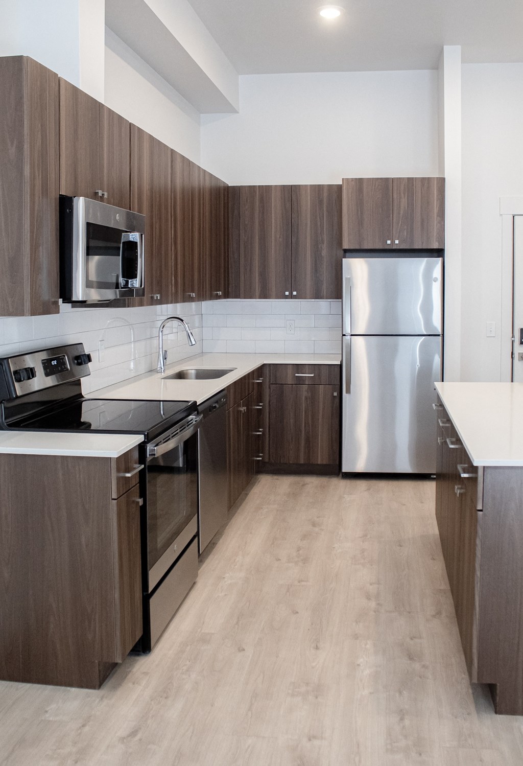 A kitchen with wooden cabinets and stainless steel appliances