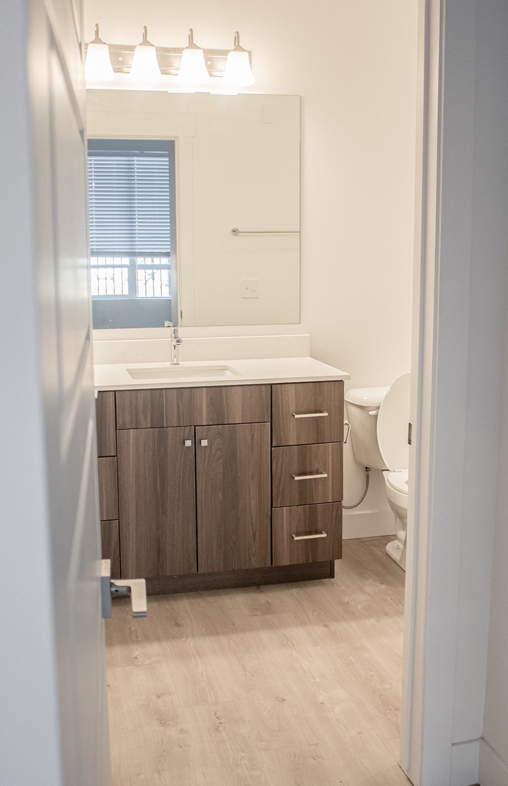 A view of a bathroom with a sink toilet and mirror