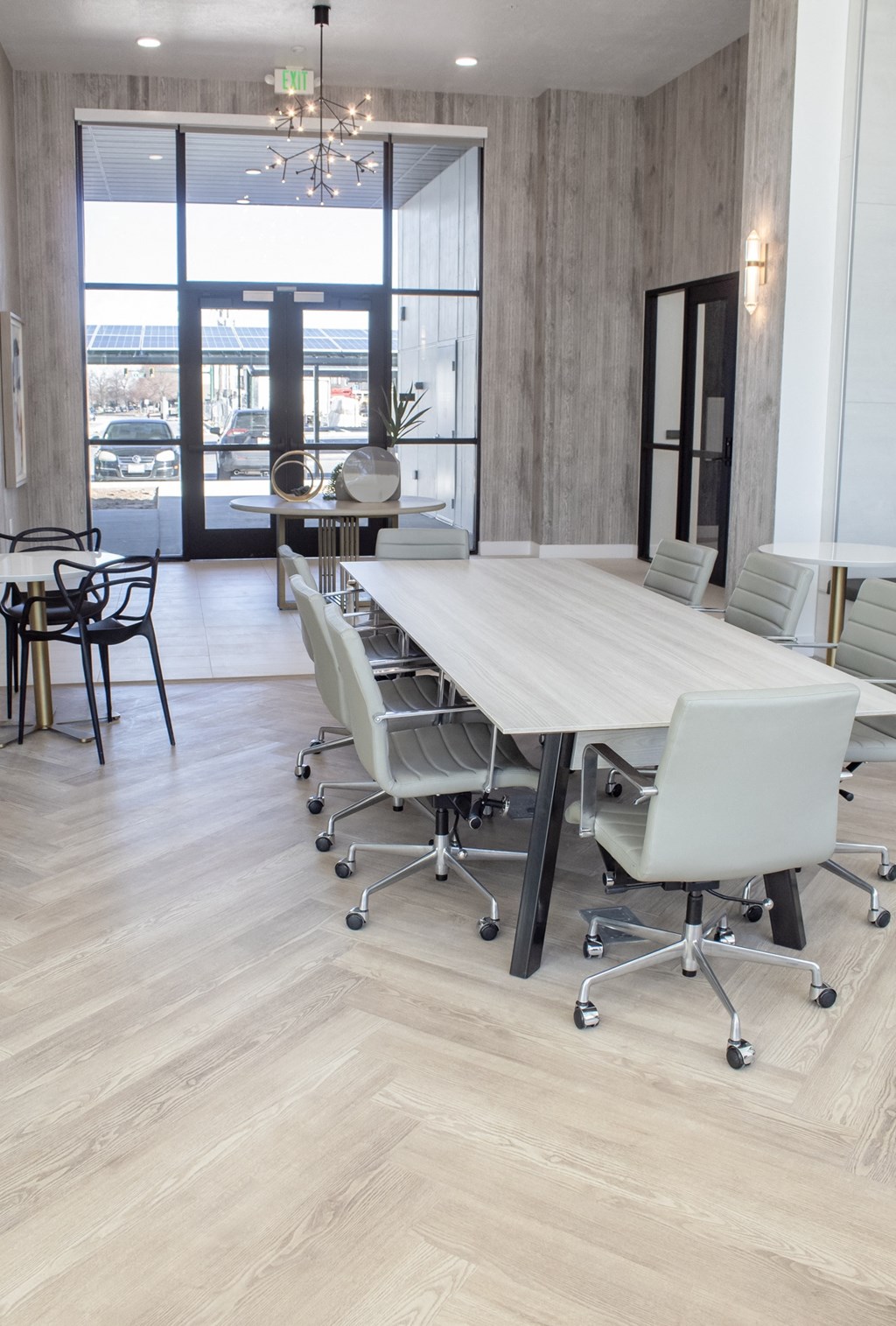 Conference room with a wooden table and white chairs