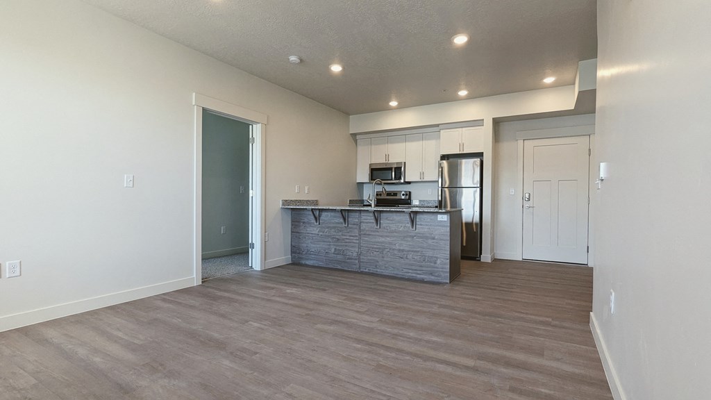 A living room with a kitchen in the background