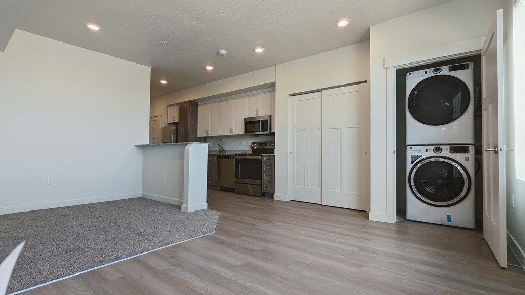 A living room with a washer and dryer