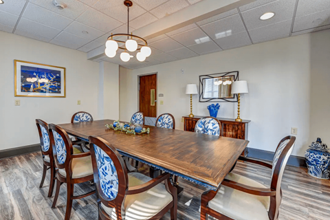 a dining room with a wooden table and chairs