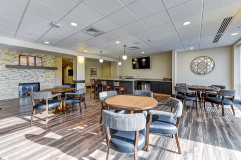 a dining room with tables and chairs and a fireplace