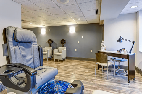 a salon room with a chair and a table with chairs