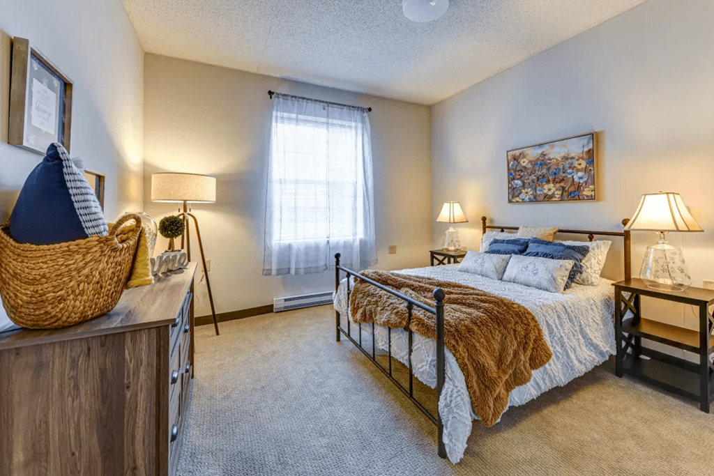 a bedroom with a bed and a window
