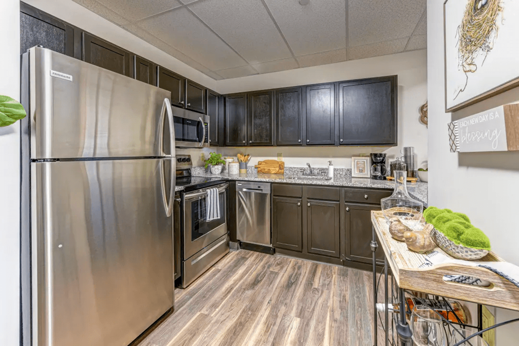 a kitchen with stainless steel appliances and a wooden table