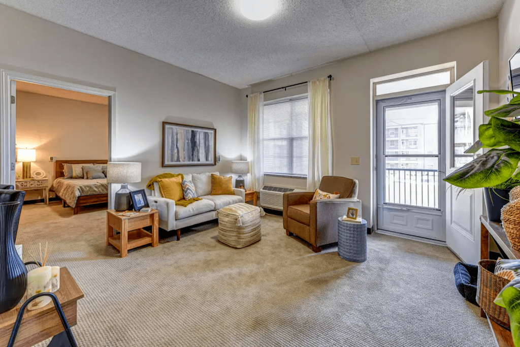 a living room with furniture and a door to a balcony