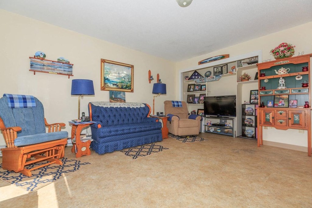 a living room filled with furniture and a tv