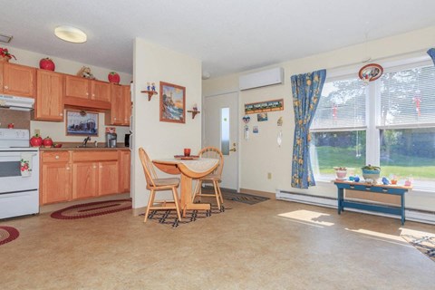 a kitchen and dining room with a table and chairs