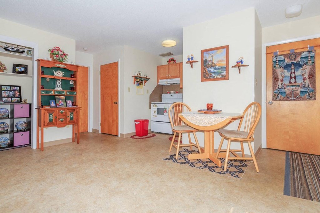 a dining room and kitchen with a table and chairs