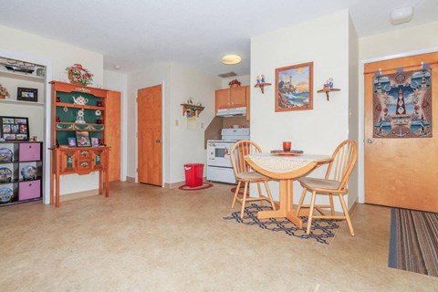 a dining room and kitchen with a table and chairs
