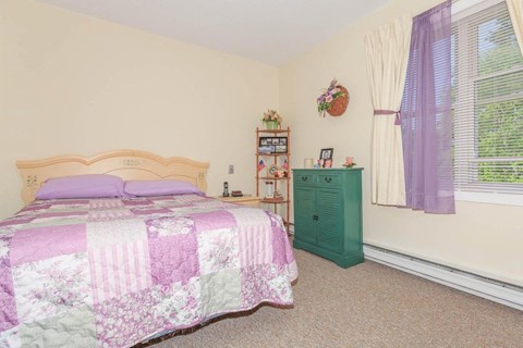 a bedroom with a bed and a green dresser