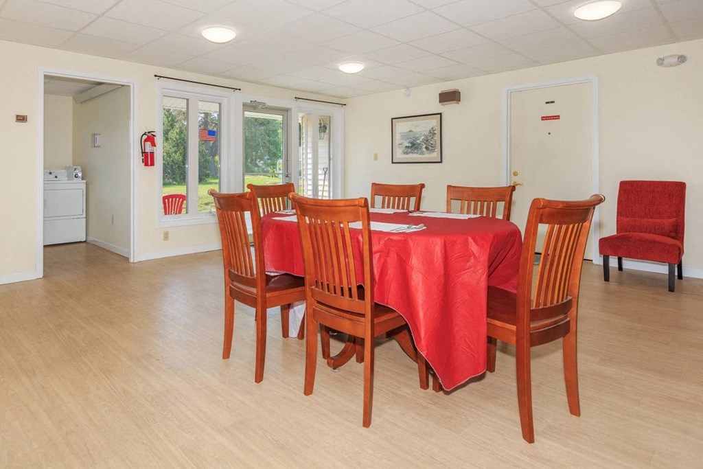 a dining room with a table and chairs
