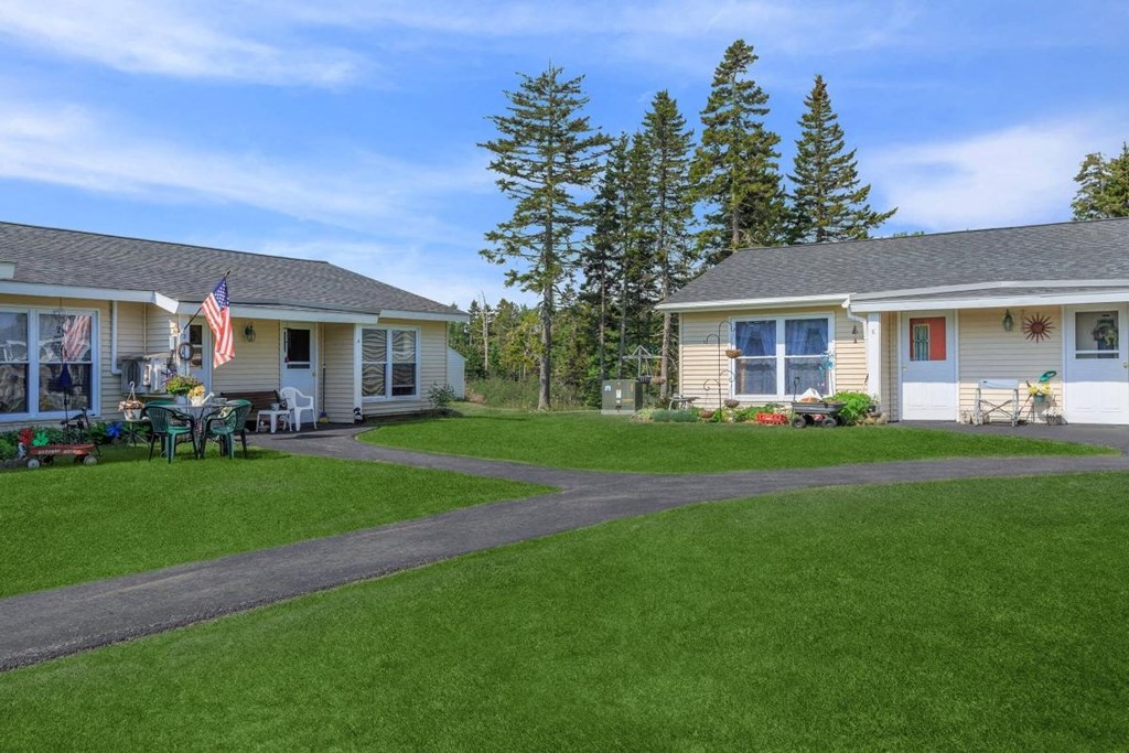 a yard in front of two houses with a lawn