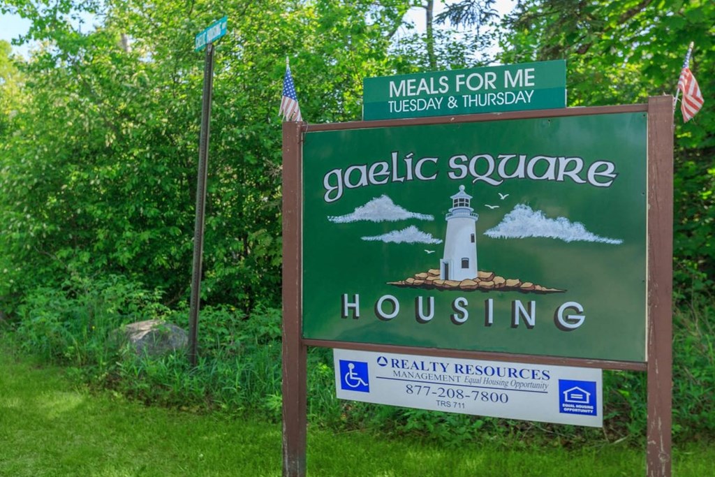 a sign that reads gaeltic square housing and a lighthouse