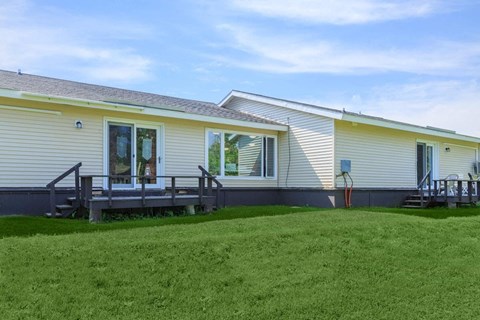 a house with a porch and a grass yard