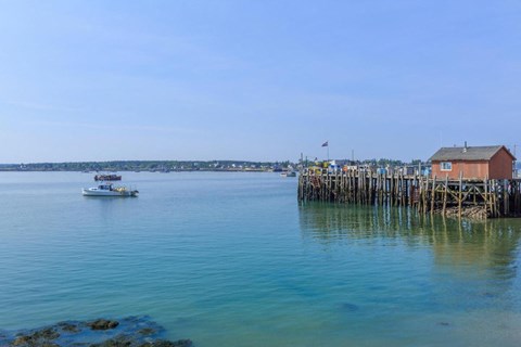 a small boat in the water near a dock