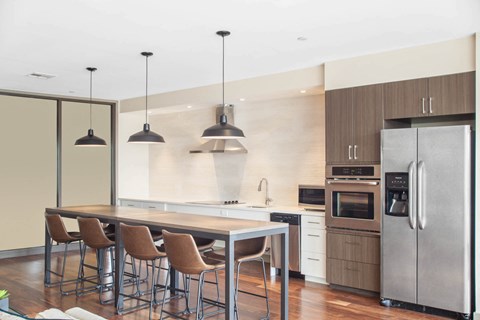 a kitchen with a large island and a table with chairs