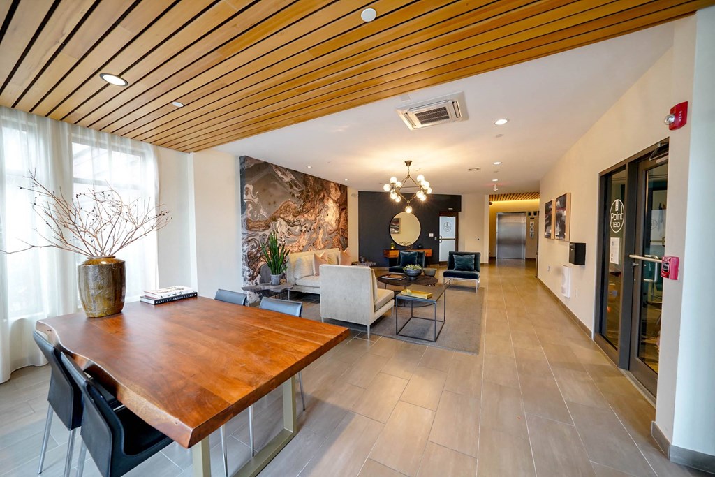 A modern dining room with a wooden table and chairs.