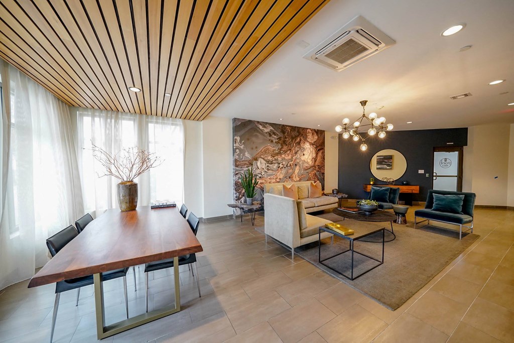 A modern dining room with a wooden table and chairs.