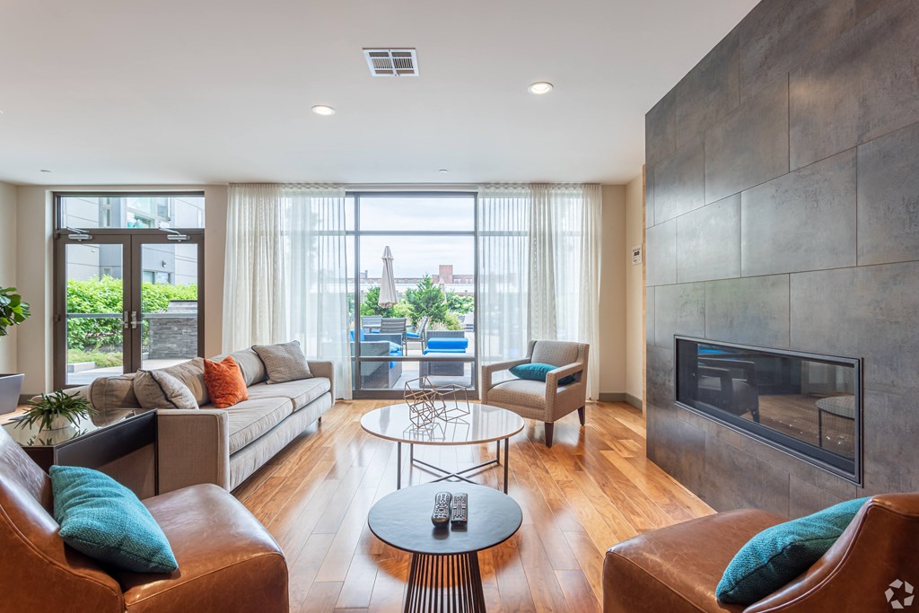A modern living room with a fireplace and a glass table.