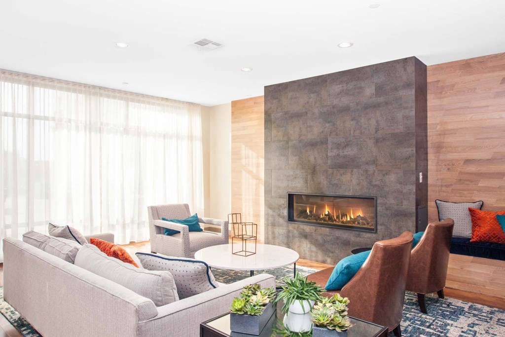 A modern living room with a fireplace and comfortable seating.