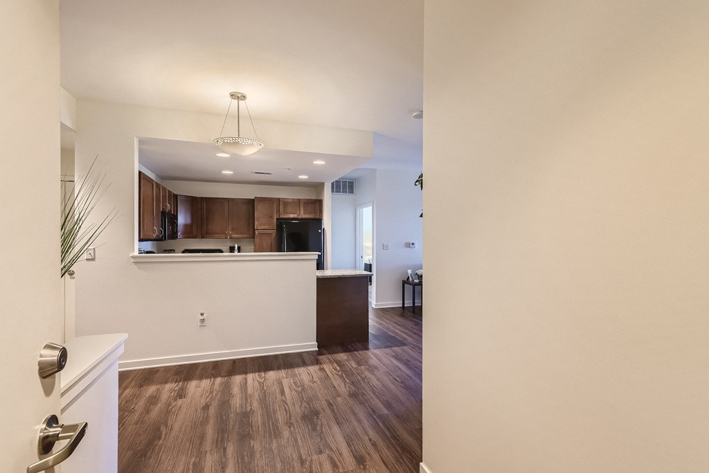 a view of a kitchen and living room from the doorway of a house
