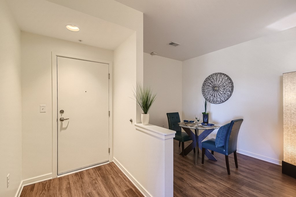 a dining room with a table and chairs and a white door