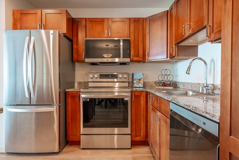 A kitchen with wooden cabinets and stainless steel appliances.