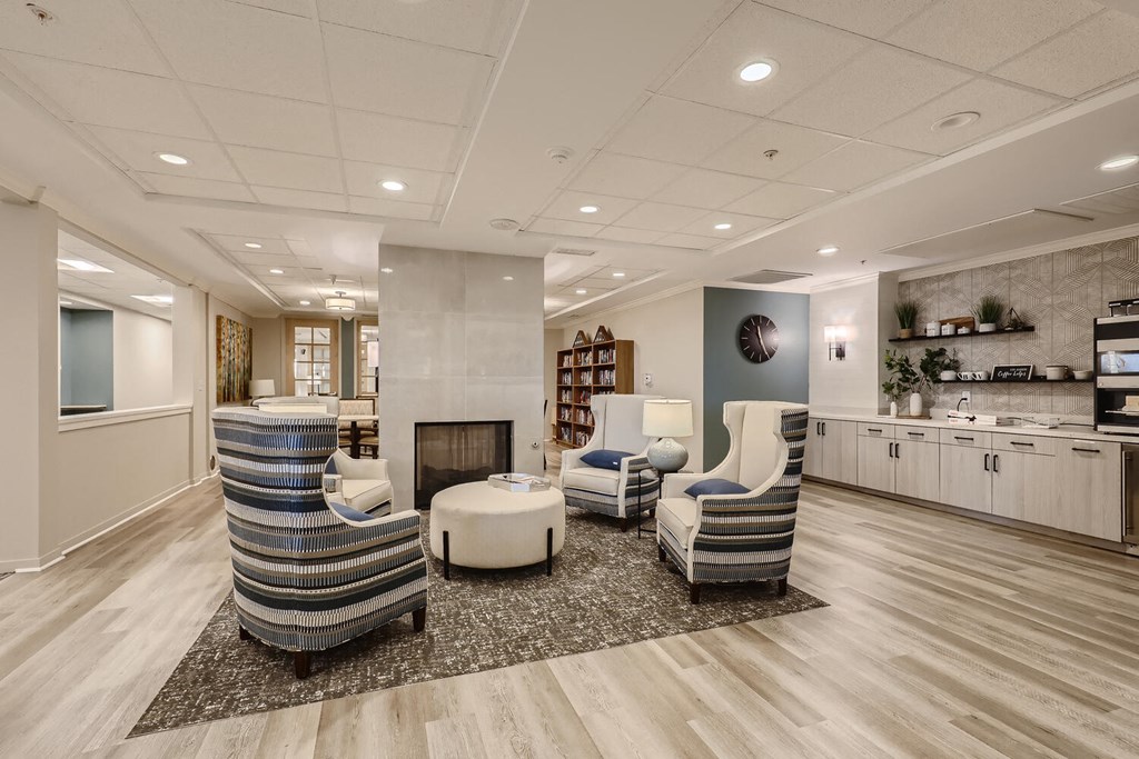 a living room with chairs and a fire place