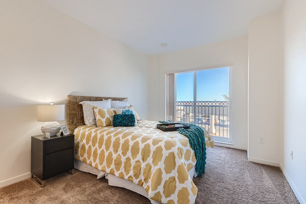 a bedroom with a large bed and a window