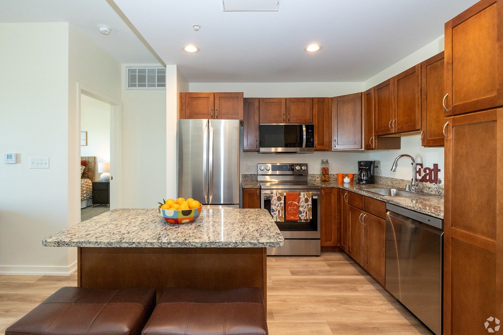 a kitchen with stainless steel appliances and a granite counter top