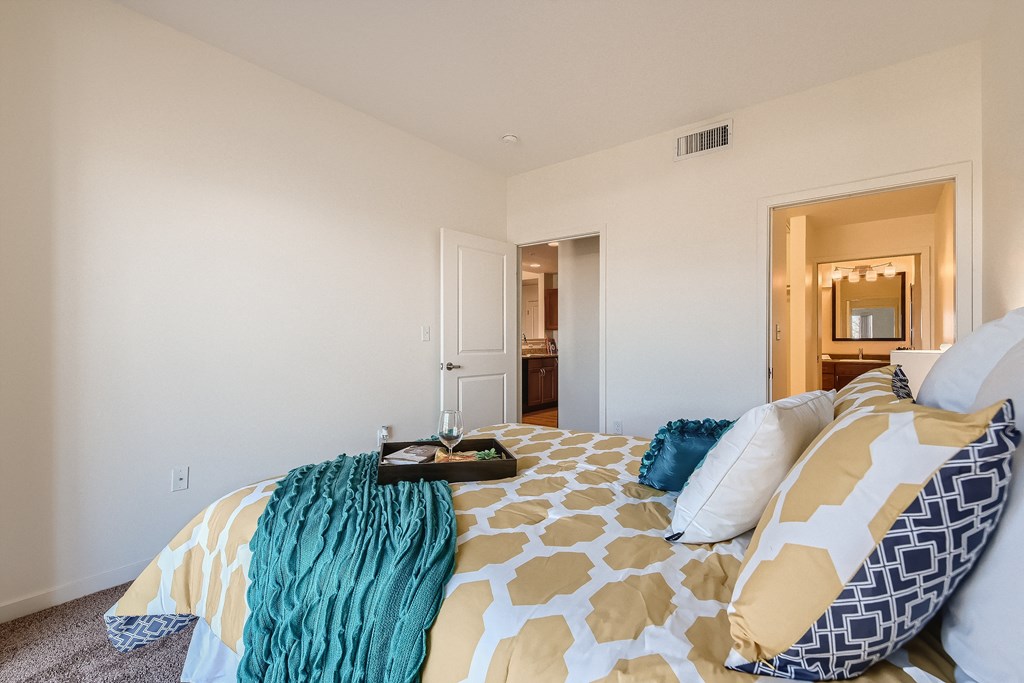 a bedroom with a large bed and a bathroom